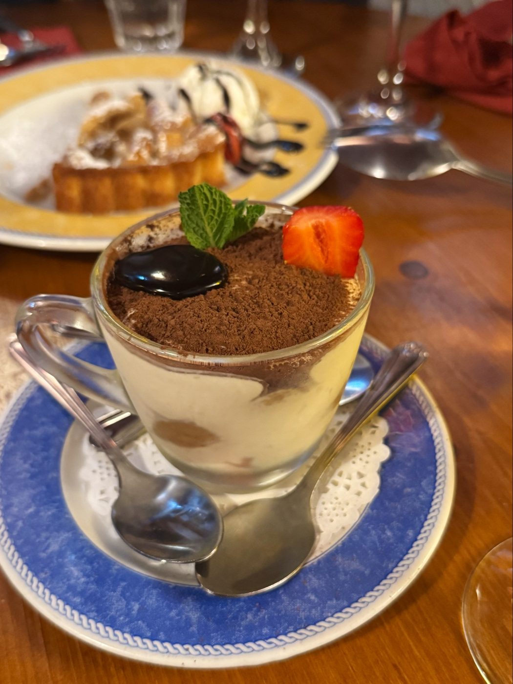 Tiramisu in a glass cup with a strawberry